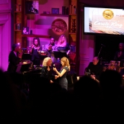 Louise Goffin passes the mic to Carole.  Photo by Elissa Kline